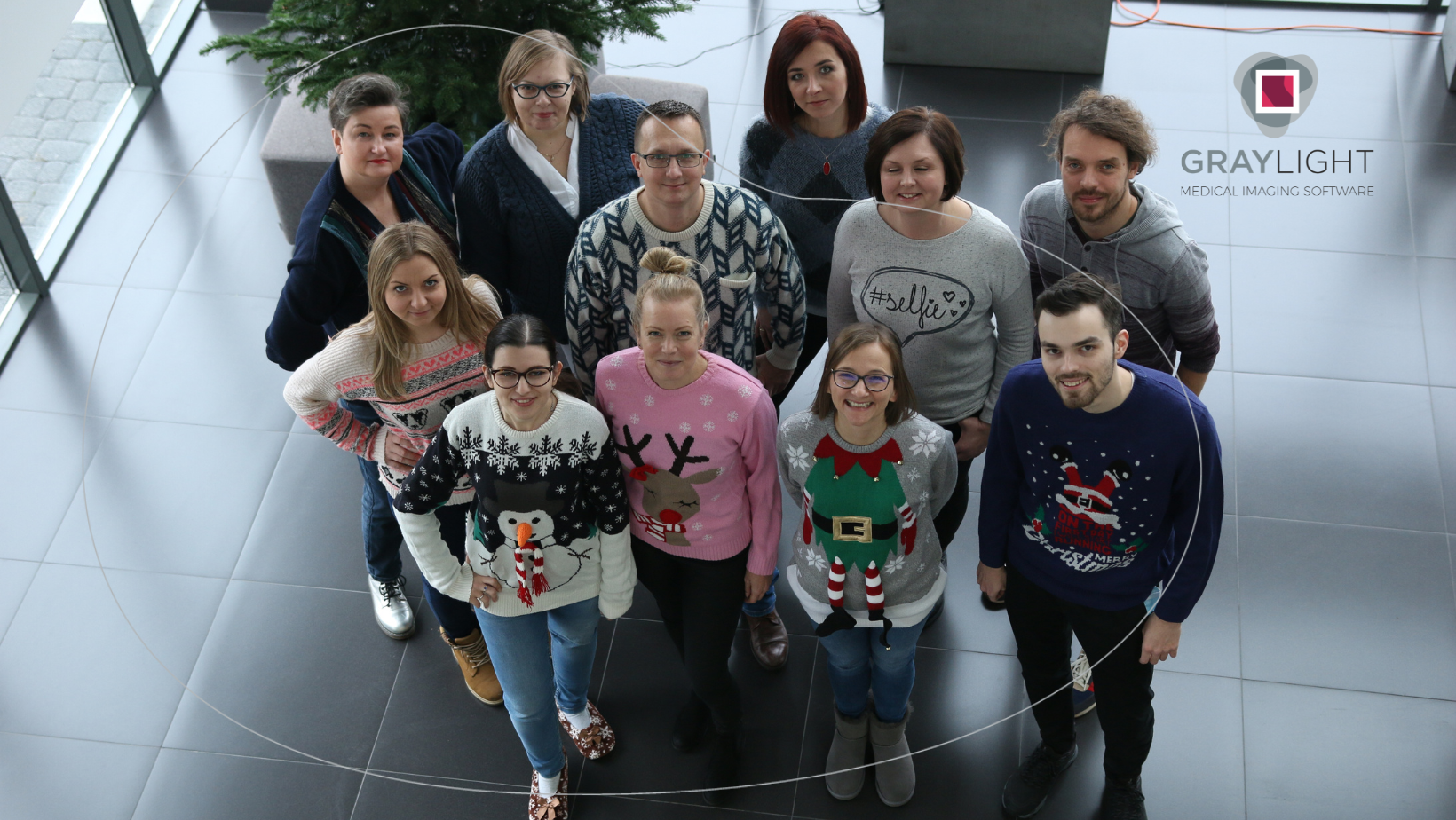 group of Graylight Imaging employees standing in christmass sweaters as an example of team provided by software outsourcing partner
