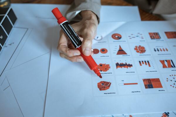 a person is analyzing data charts and graphs to optimize ground truth in medical project